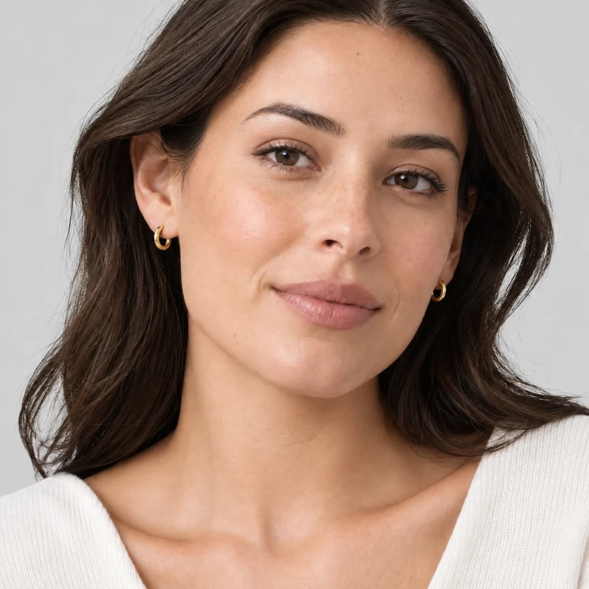 Micro Huggie Hoops, 14k Solid Gold — worn on a model