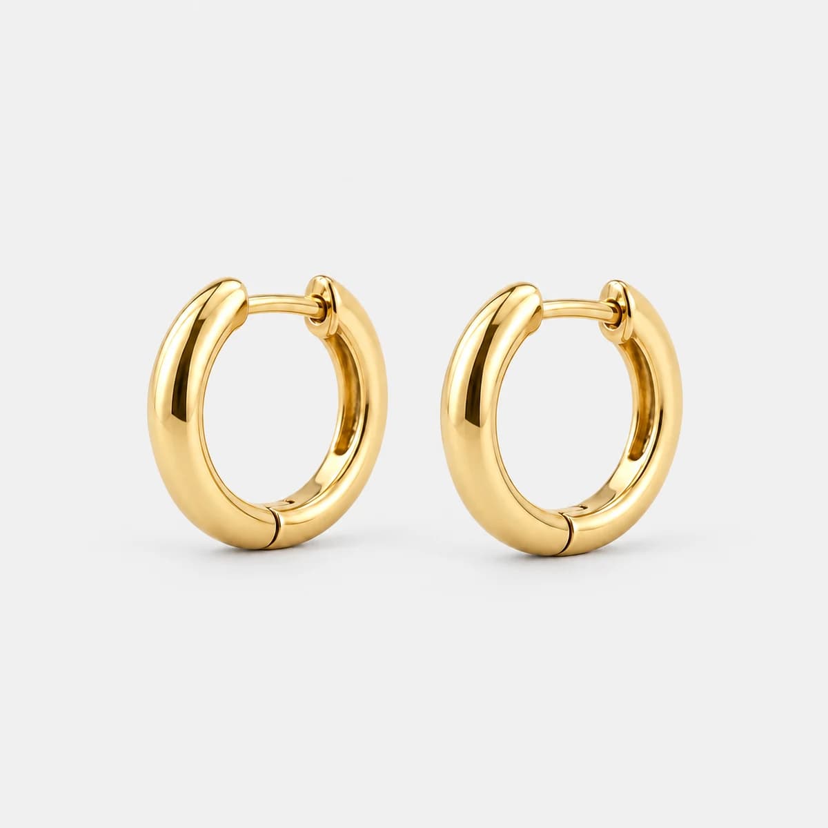 Micro Huggie Hoops, 14k Solid Gold — studio view